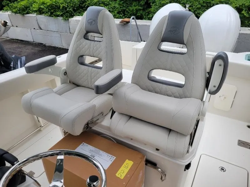 Slide: The Image of 2025 Sailfish 272 CC boat with dual captain's chairs and a steering wheel. - 29