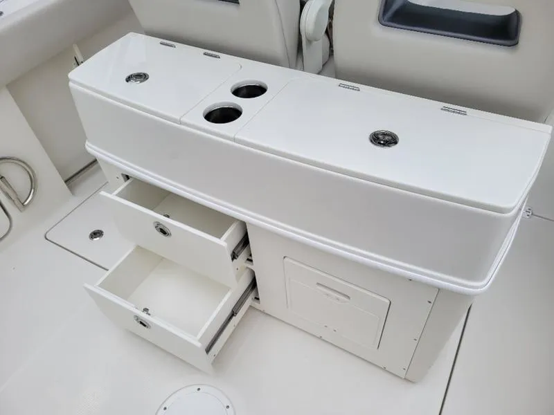 Slide: The Image of 2025 Sailfish 272 CC boat interior with storage compartments and cup holders. - 30