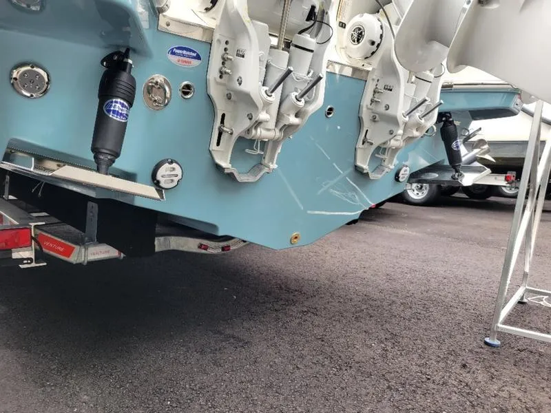 Slide: The Image of Sailfish 272 CC 2025 model boat rear view showing outboard motor mounts and trailer. - 34