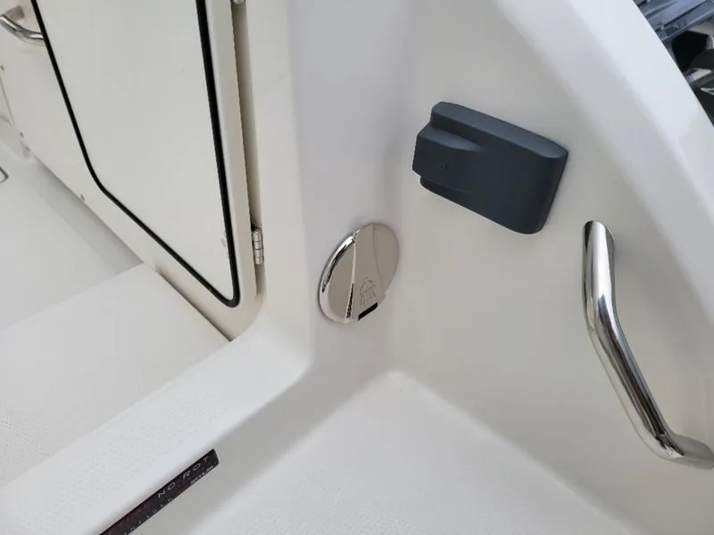 Slide: The Image of 2025 Sailfish 272 CC boat interior detail with door, handle, and fixtures. - 4