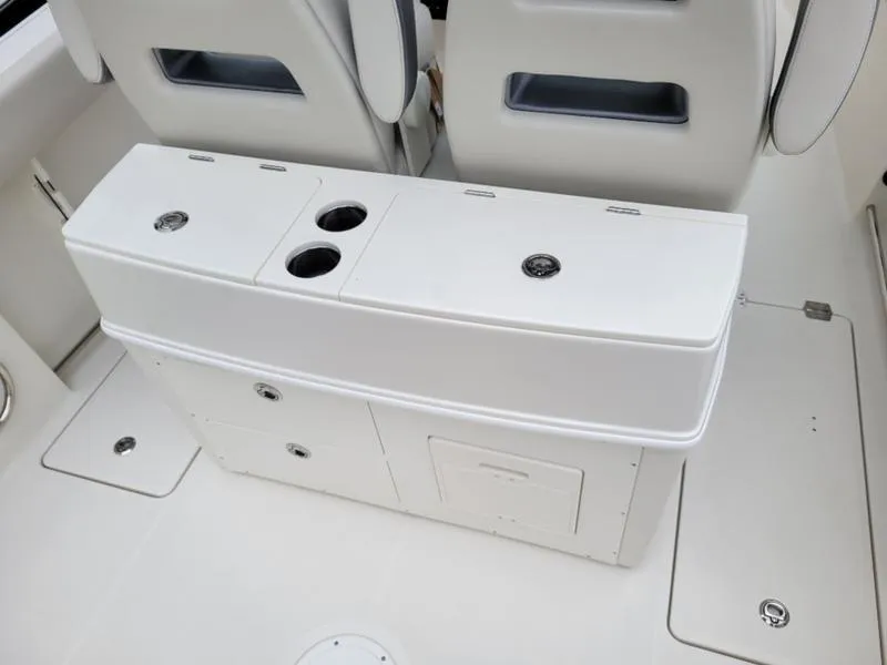 Slide: The Image of 2025 Sailfish 272 CC center console boat interior with storage compartments and cup holders. - 5