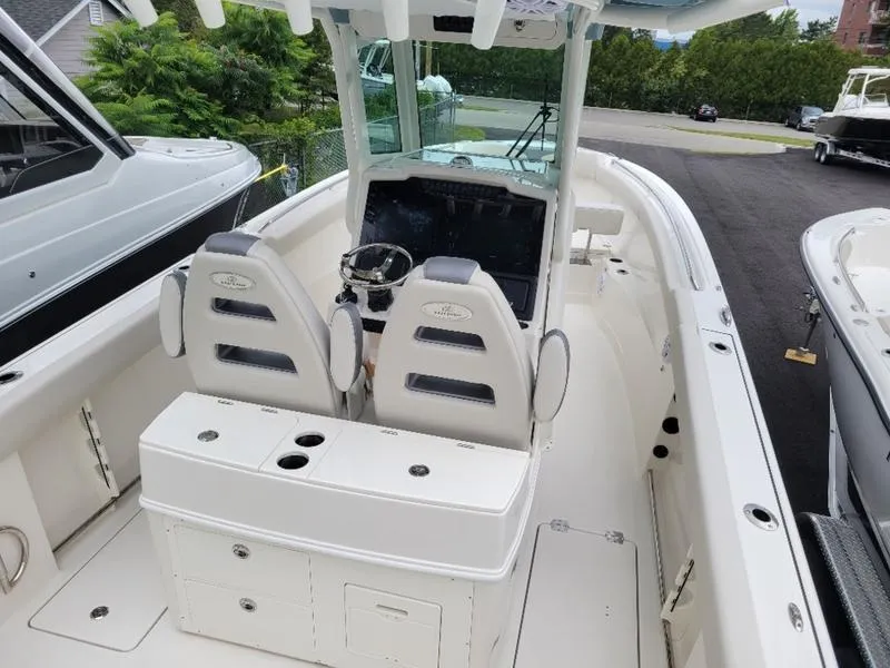 Slide: The Image of 2025 Sailfish 272 CC center console boat with dual captain's chairs and modern dashboard. - 6