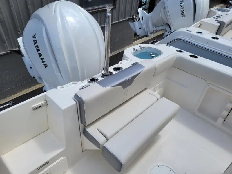 Slide: The Image of 2025 Sailfish 241 CC boat with Yamaha outboard engines and cushioned seating. - 10