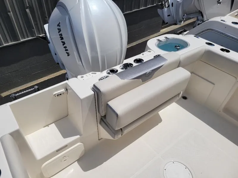 Slide: The Image of 2025 Sailfish 241 CC boat with Yamaha outboard motor and seating area. - 11