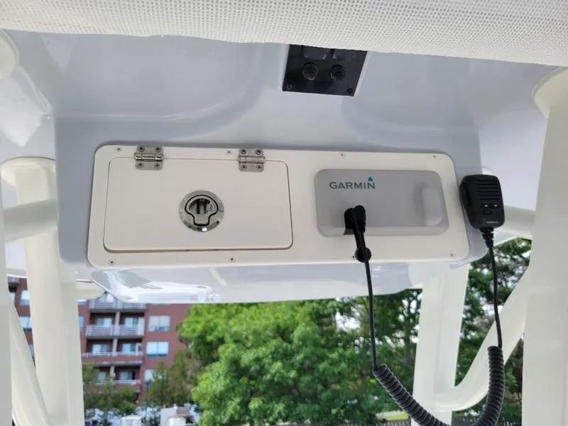 Slide: The Image of Control panel of 2025 Sailfish 241 CC boat with Garmin device and microphone. - 12