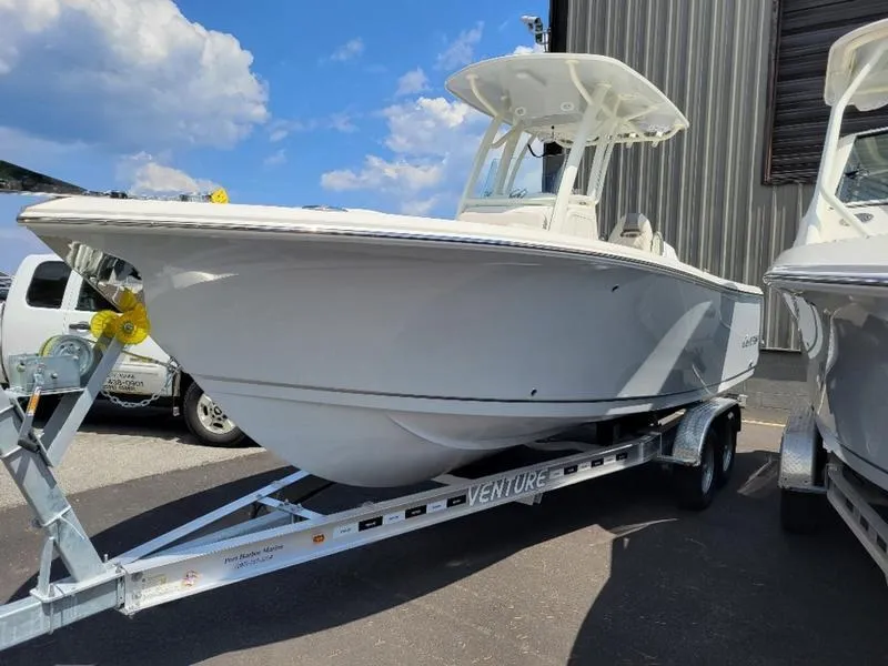 Slide: The Image of 2025 Sailfish 241 CC boat on a Venture trailer, parked outdoors. - 3