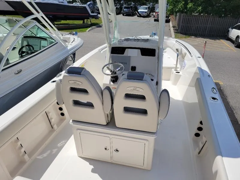 Slide: The Image of 2025 Sailfish 241 CC center console boat interior with dual captain's chairs and steering wheel. - 6