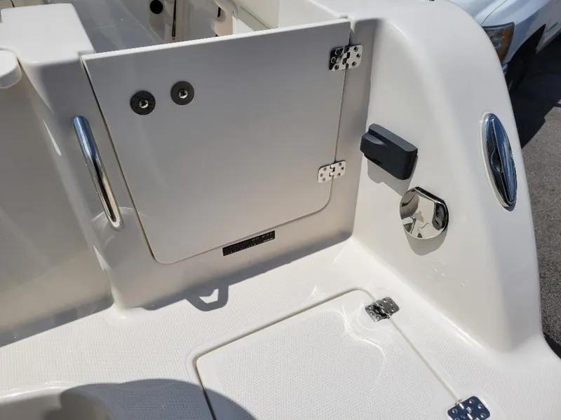 Slide: The Image of 2025 Sailfish 241 CC boat interior, featuring storage compartments and stainless steel hardware. - 9