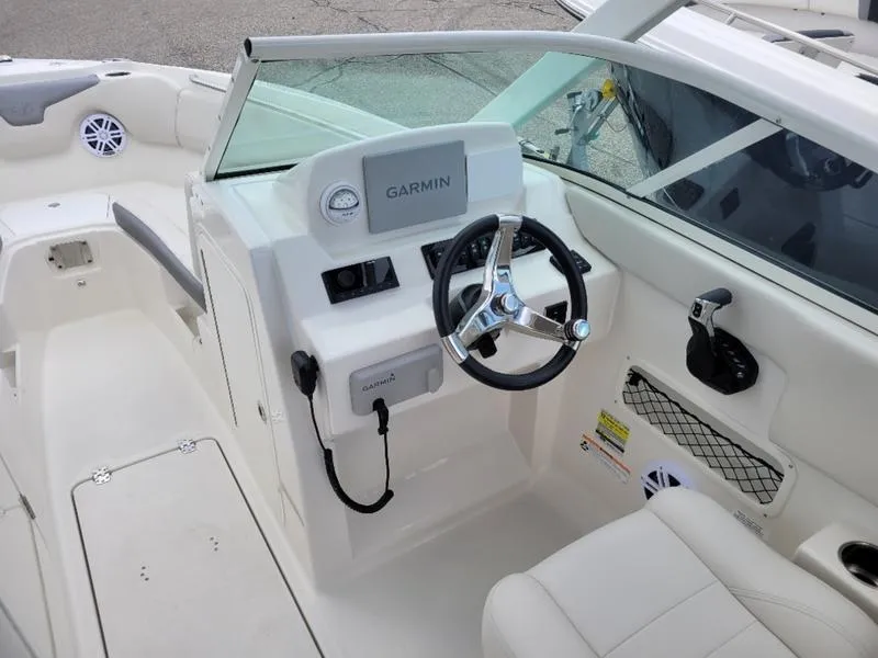 Slide: The Image of 2025 Sailfish 236 DC boat interior with cushioned seating and open deck layout. - 11