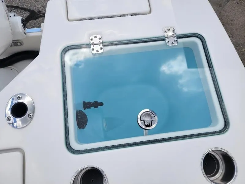 Slide: The Image of 2025 Sailfish 236 DC boat interior with cushioned seating and steering wheel. - 12