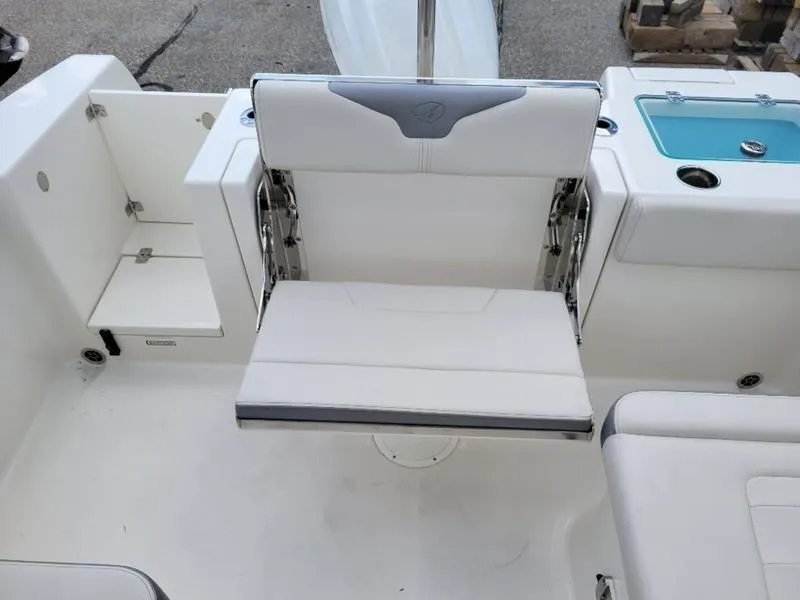 Slide: The Image of 2025 Sailfish 236 DC boat cockpit with steering wheel and comfortable seating. - 15