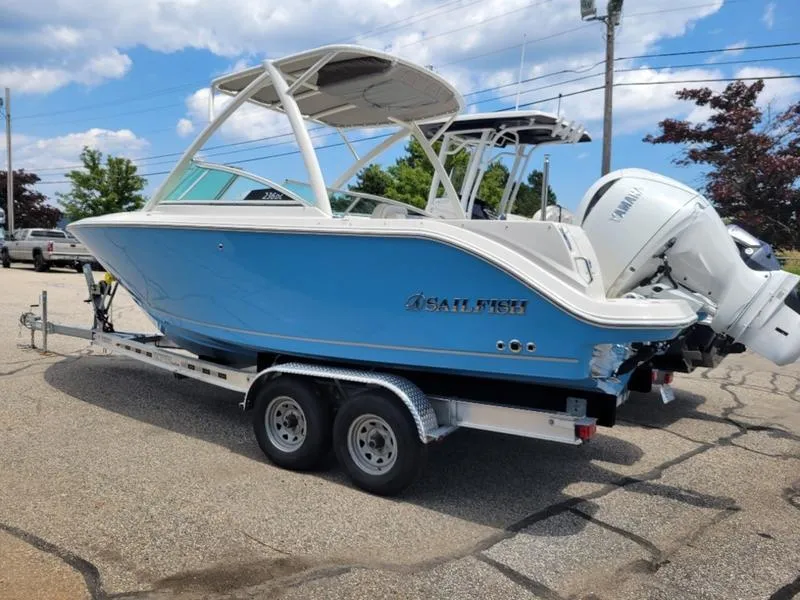 Slide: The Image of 2025 Sailfish 236 DC boat interior with seating and steering wheel, on calm water. - 5