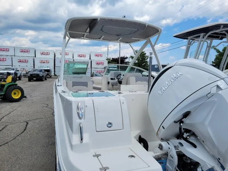 Slide: The Image of 2025 Sailfish 236 DC boat docked at marina, clear sunny day. - 6
