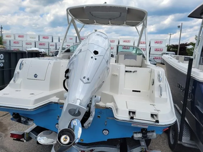 Slide: The Image of 2025 Sailfish 236 DC boat docked, featuring Yamaha outboard motor, clear skies, and calm waters. - 8