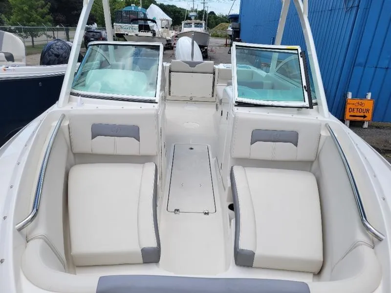 Slide: The Image of 2025 Sailfish 236 DC boat docked on a sunny day, featuring a sleek design. - 9