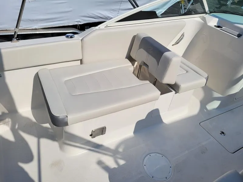 Slide: The Image of 2025 Sailfish 236 DC boat interior with white seating and modern design. - 12