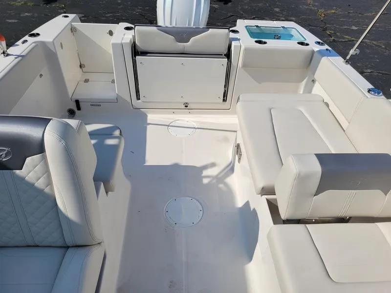 Slide: The Image of 2025 Sailfish 236 DC boat interior with white seating and storage compartments. - 13