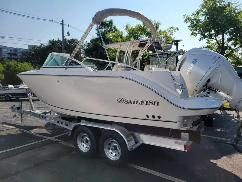 Slide: The Image of 2025 Sailfish 236 DC boat on trailer with Yamaha engine in parking lot. - 4