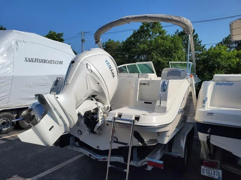 Slide: The Image of 2025 Sailfish 236 DC boat with Yamaha outboard motor, parked on a trailer. - 6