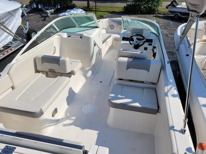 Slide: The Image of 2025 Sailfish 236 DC boat interior with seating and steering wheel. - 7