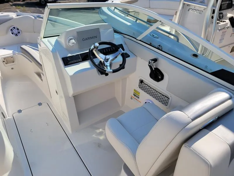 Slide: The Image of 2025 Sailfish 236 DC boat interior with Garmin navigation system and comfortable seating. - 8