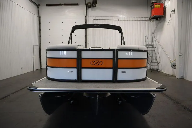 Slide: The Image of 2024 Bentley Pontoons 203 Bolt Tri-Toon in a showroom, rear view. - 2