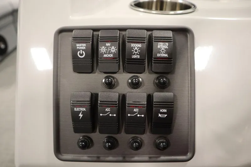 Slide: The Image of Control panel of 2024 Bentley Pontoons 203 Bolt Tri-Toon with various switches. - 23