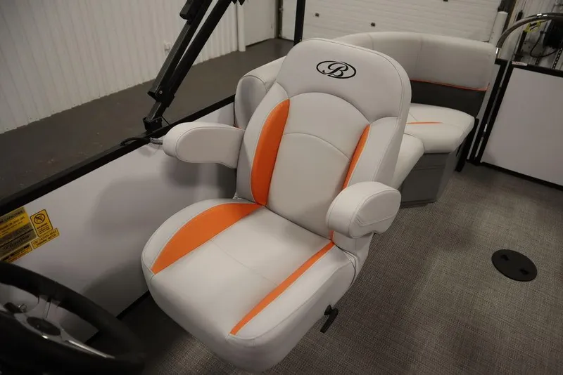 Slide: The Image of 2024 Bentley Pontoons 203 Bolt Tri-Toon interior with stylish seating and orange accents. - 27