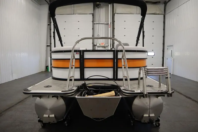 Slide: The Image of 2024 Bentley Pontoons 203 Bolt Tri-Toon in a spacious indoor showroom. - 3