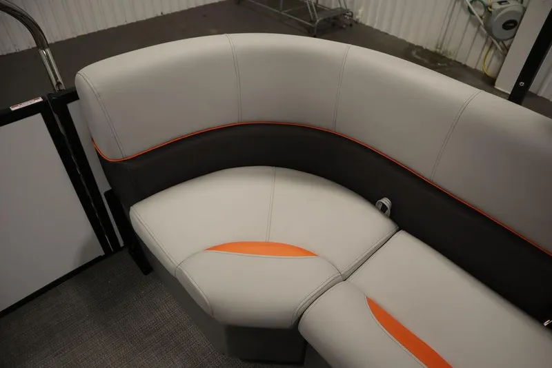 Slide: The Image of 2024 Bentley Pontoons 203 Bolt Tri-Toon interior seating with modern design and orange accents. - 34
