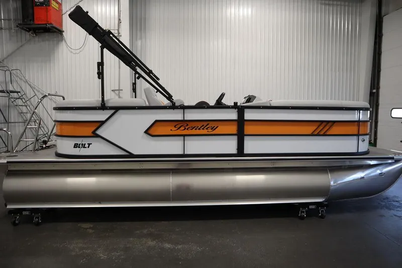 Slide: The Image of 2024 Bentley Pontoons 203 Bolt Tri-Toon in a showroom, side view. - 5