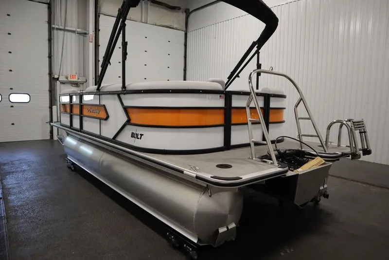 Slide: The Image of 2024 Bentley Pontoons 203 Bolt Tri-Toon in a garage, showcasing sleek design and vibrant colors. - 6