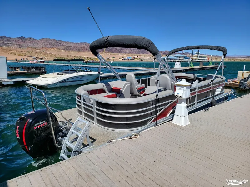 Slide: The Image of 2021 Bennington L25 Stern Radius pontoon boat docked at a marina. - 4