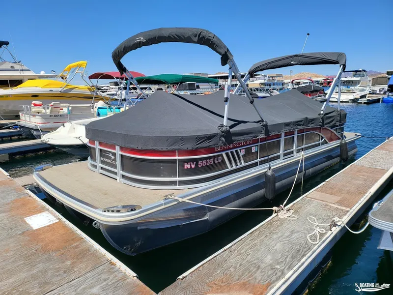 Slide: The Image of 2021 Bennington L25 Stern Radius pontoon boat docked with cover on. - 7