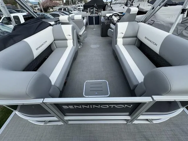 Slide: The Image of 2024 Bennington 22 SSR pontoon boat interior with gray and white seating. - 12