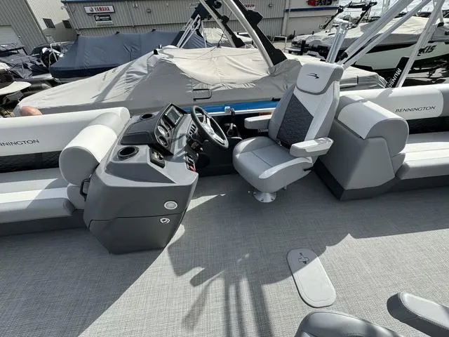 Slide: The Image of 2024 Bennington 22 SSR boat interior with captain's chair and control console. - 5