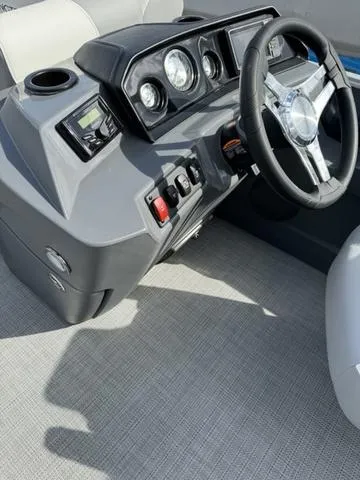Slide: The Image of 2024 Bennington 22 SSR boat dashboard with steering wheel and control panel. - 6