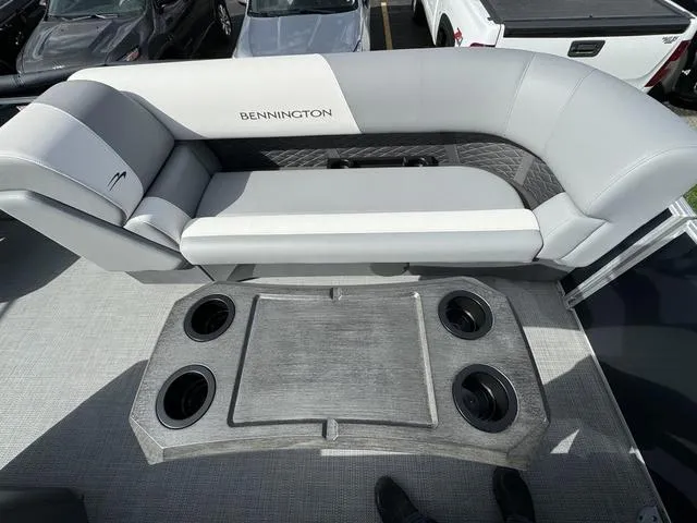 Slide: The Image of 2024 Bennington 22 SSR boat interior with gray seating and cup holders. - 9