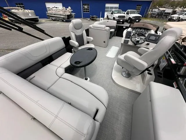 Slide: The Image of 2024 Starcraft SLS 3 Q DH pontoon boat interior with luxurious seating and modern helm. - 3