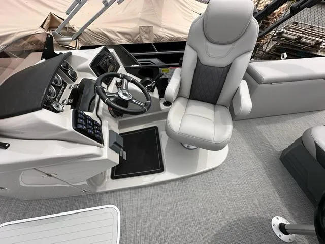 Slide: The Image of 2024 Starcraft SLS 3 Q DH boat cockpit with captain's chair and control panel. - 5
