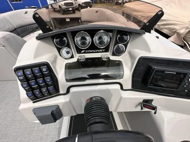 Slide: The Image of 2024 Starcraft SLS 3 Q DH boat dashboard with gauges and controls. - 6