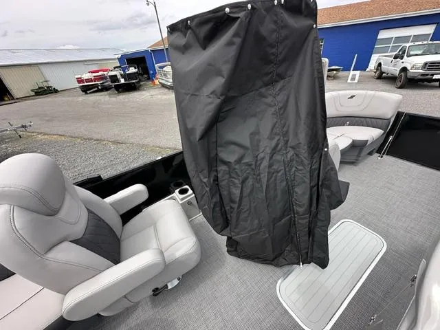 Slide: The Image of 2024 Starcraft SLS 3 Q DH boat interior with gray seating and black privacy curtain. - 9