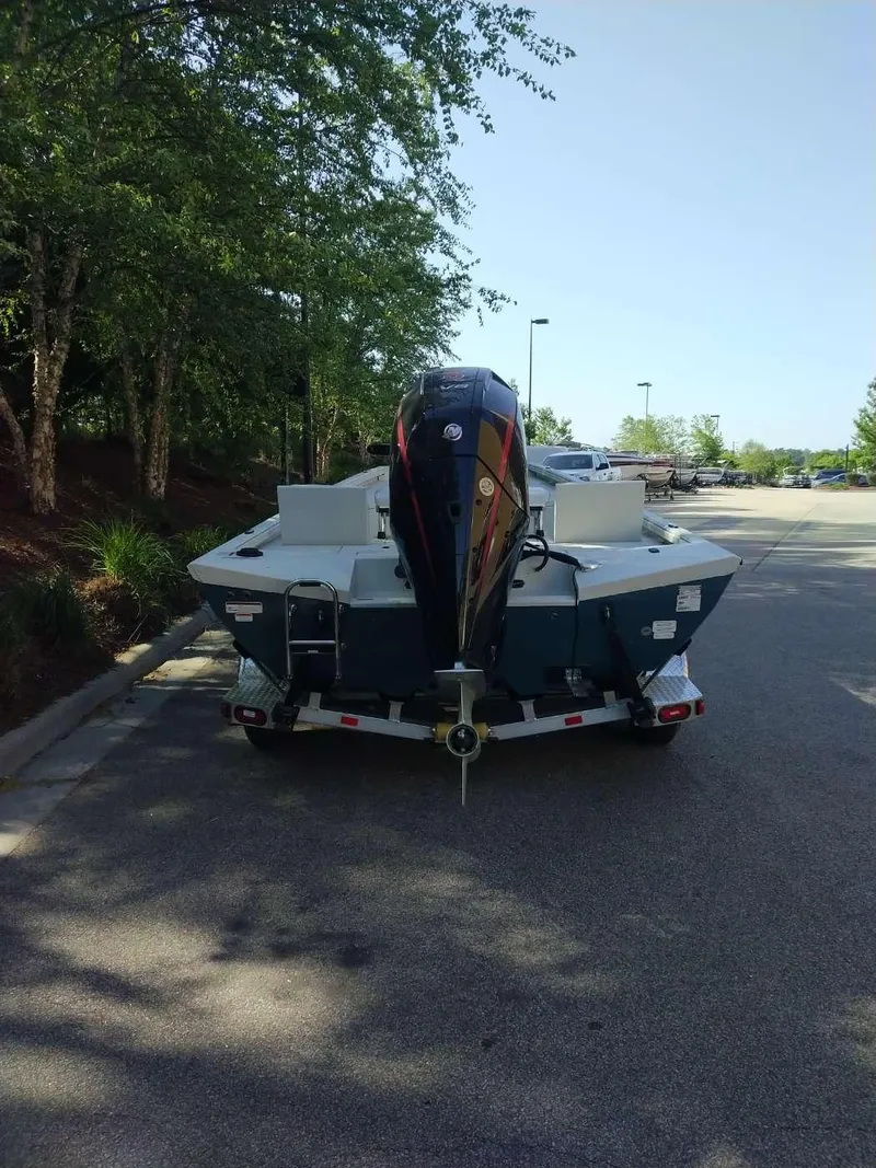 Slide: The Image of 2024 Ranger RB210 boat on trailer in parking lot. - 1