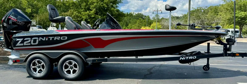 Slide: The Image of 2024 Nitro Z20 boat on trailer, sleek design, parked outdoors. - 0
