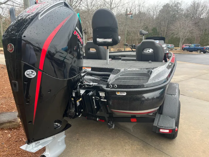 Slide: The Image of 2024 Nitro Z20 boat with powerful engine, parked on a trailer in a driveway. - 4