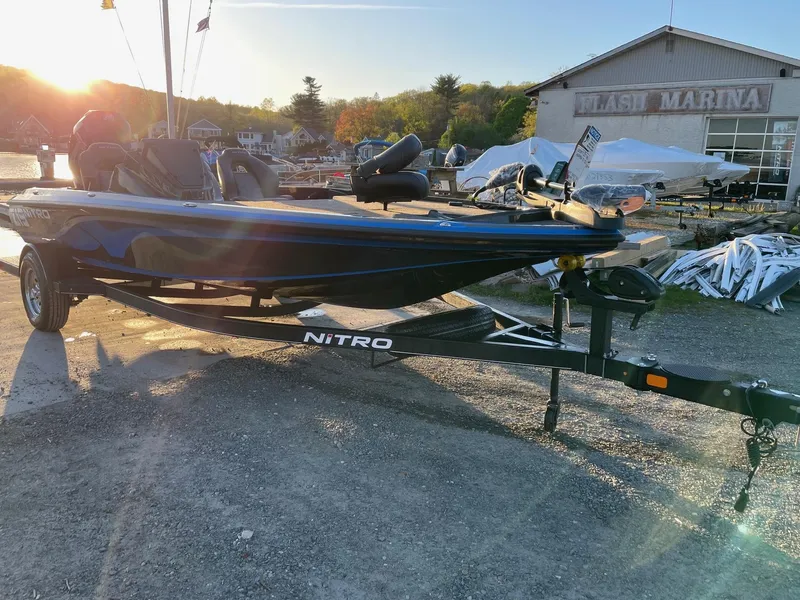 Slide: The Image of 2024 Nitro Z19 boat on trailer at marina during sunset. - 5
