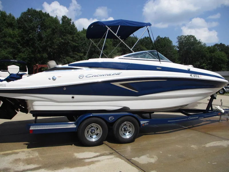 Slide: The Image of 2019 Crownline Eclipse E255 boat on a trailer with blue and white exterior. - 1