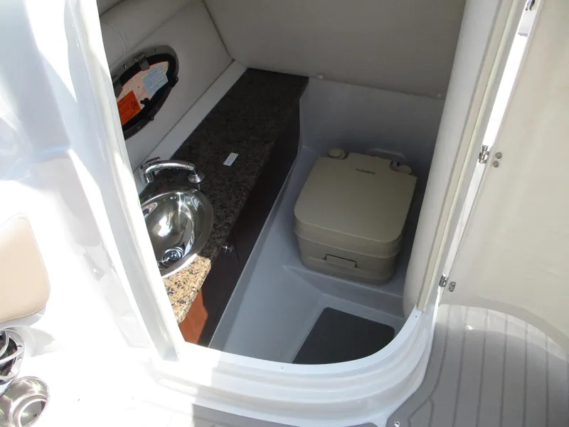 Slide: The Image of 2019 Crownline Eclipse E255 boat interior with sink and portable toilet. - 11