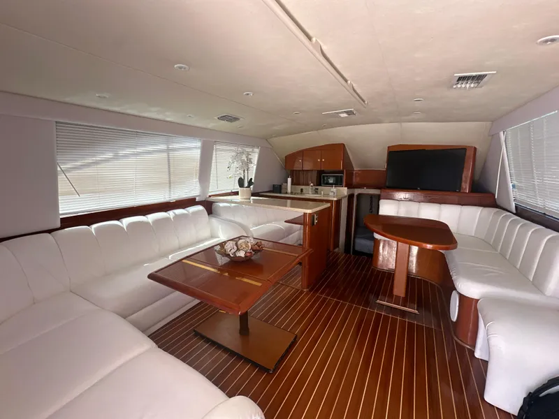 Slide: The Image of Luxurious interior of 1999 Ocean 45 Super Sport yacht with white leather seating and wooden accents. - 13