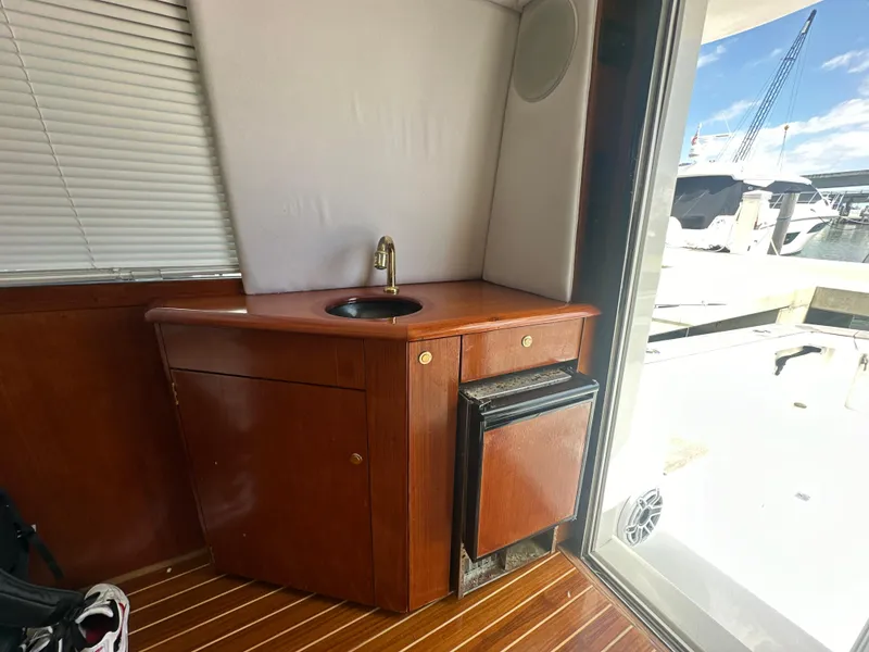 Slide: The Image of 1999 Ocean 45 Super Sport yacht interior with sink and mini-fridge. - 17